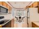Eat-in kitchen features wood cabinets and bay window dining nook at 71 Woodland Cir, Highlands Ranch, CO 80126