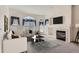 Bright living room features a fireplace, neutral walls, and multiple windows at 71 Woodland Cir, Highlands Ranch, CO 80126