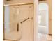 Bright shower featuring glass doors, white tiling, and a grab bar for safety at 71 Woodland Cir, Highlands Ranch, CO 80126