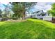 Backyard featuring an upper-level deck, storage shed, and lush green lawn at 7840 W Portland Ave, Littleton, CO 80128