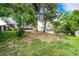 Landscaped backyard with mature trees, a deck, and a fence surrounding the perimeter at 7840 W Portland Ave, Littleton, CO 80128