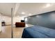 Basement showcasing painted floor and walls, ceiling, sofa, tv and fish tank at 7840 W Portland Ave, Littleton, CO 80128