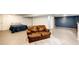 Basement featuring a sofa sitting on a rug, a bed, and access to other spaces at 7840 W Portland Ave, Littleton, CO 80128