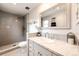 Bathroom featuring tiled walk-in shower, marble countertop vanity with oval sink and framed mirror at 7840 W Portland Ave, Littleton, CO 80128
