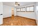 Bedroom featuring a laminate floor, closet, and natural light at 7840 W Portland Ave, Littleton, CO 80128