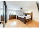 Primary bedroom features hardwood floors, a ceiling fan, and plenty of light at 7840 W Portland Ave, Littleton, CO 80128