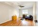 Bedroom with hardwood floors, ceiling fan, window with blinds, dresser and upholstered chair at 7840 W Portland Ave, Littleton, CO 80128