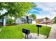Charming two-story home with a well-manicured lawn, large driveway, and a gray and white facade at 7840 W Portland Ave, Littleton, CO 80128