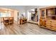 Open-concept foyer featuring wood floors, a staircase leading upstairs, and views to the dining room at 7840 W Portland Ave, Littleton, CO 80128