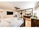 Spacious main bedroom features hardwood floors and mirrored closet doors at 7840 W Portland Ave, Littleton, CO 80128