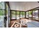Sunroom featuring a tiled floor and walls of glass, with views of the outside deck at 7840 W Portland Ave, Littleton, CO 80128