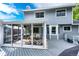 Back of house with a sunroom extension and deck featuring a geometric tile pattern at 7840 W Portland Ave, Littleton, CO 80128