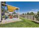 Backyard patio with pergola, seating area, and grassy lawn at 15983 E Warner Dr, Denver, CO 80239