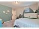 bedroom with mountain mural, built-in shelves, and a double bed at 15983 E Warner Dr, Denver, CO 80239