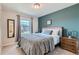 Spacious bedroom with large window and accent wall at 15983 E Warner Dr, Denver, CO 80239