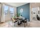 Modern dining area with glass table and an accent wall at 15983 E Warner Dr, Denver, CO 80239