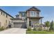 Two-story home with stone accents and a landscaped yard at 15983 E Warner Dr, Denver, CO 80239