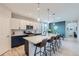 Open concept kitchen with white and blue cabinets and an island at 15983 E Warner Dr, Denver, CO 80239