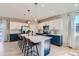 Modern kitchen with white and blue cabinets, and an island at 15983 E Warner Dr, Denver, CO 80239