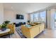 Bright living room featuring mustard yellow sofas and large windows at 15983 E Warner Dr, Denver, CO 80239