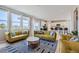 Living room with mustard yellow sofas and a geometric rug at 15983 E Warner Dr, Denver, CO 80239