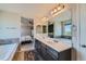 Main bathroom with double sinks, soaking tub, and shower at 15983 E Warner Dr, Denver, CO 80239