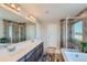 Main bathroom with double sinks, walk in shower and soaking tub at 15983 E Warner Dr, Denver, CO 80239