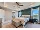 Main bedroom with tray ceiling, window seat, and en-suite bath at 15983 E Warner Dr, Denver, CO 80239