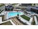 Community pool with lounge chairs, grassy areas, and a clubhouse at 15983 E Warner Dr, Denver, CO 80239