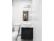 Stylish bathroom with a vessel sink on a black cabinet and gray penny tile flooring at 5945 Dudley Ct, Arvada, CO 80004