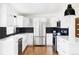 Sleek kitchen with white cabinets, stainless steel appliances, dark backsplash, and a modern faucet fixture at 5945 Dudley Ct, Arvada, CO 80004