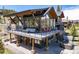 Relax in a modern backyard with an expansive deck, outdoor seating, grill, and a luxurious hot tub at 2250 Highlands Dr, Breckenridge, CO 80424
