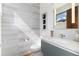 Modern bathroom featuring sleek gray tile, contemporary fixtures, and natural light at 2250 Highlands Dr, Breckenridge, CO 80424