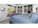 Serene bedroom featuring large windows overlooking a lush forest landscape, creating a tranquil and inviting atmosphere at 2250 Highlands Dr, Breckenridge, CO 80424