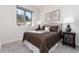 Cozy bedroom with soft lighting, decorative art, and a comfortable bed dressed in brown tones at 2250 Highlands Dr, Breckenridge, CO 80424