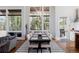 Dining room with seating for eight, modern lighting, large windows and access to the kitchen at 2250 Highlands Dr, Breckenridge, CO 80424