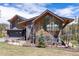 Striking mountain home with a mix of wood and dark siding and a garage beneath a gabled roofline at 2250 Highlands Dr, Breckenridge, CO 80424