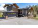 Close up exterior featuring a 2-car garage, stone accents, and concrete driveway at 2250 Highlands Dr, Breckenridge, CO 80424