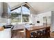 Sleek modern kitchen with an island, stainless steel appliances, and large windows with a scenic view at 2250 Highlands Dr, Breckenridge, CO 80424