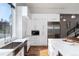 Bright kitchen with white cabinets and stainless steel appliances with an island and wood floors at 2250 Highlands Dr, Breckenridge, CO 80424
