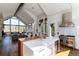 Bright, modern kitchen featuring an island with seating, Wolf range, and vaulted ceilings with grand windows at 2250 Highlands Dr, Breckenridge, CO 80424