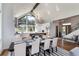 Bright open-concept living space with a kitchen, dining area, staircase, and a forest view at 2250 Highlands Dr, Breckenridge, CO 80424
