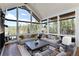 Bright living space with vaulted ceilings and large picture windows with views of the forest and backyard at 2250 Highlands Dr, Breckenridge, CO 80424