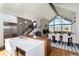 Open-concept kitchen flows into the living and dining area, featuring large windows, a fireplace, and modern finishes at 2250 Highlands Dr, Breckenridge, CO 80424