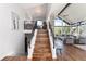 Elegant wooden staircase leading to a bright, open living space with stunning views and high ceilings at 2250 Highlands Dr, Breckenridge, CO 80424