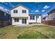 Exterior shot of the back of the home with lawn and sliding glass door at 9960 Kline St, Broomfield, CO 80021