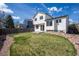 Well-manicured backyard features lush green lawn, low maintenance landscaping, and concrete patio for outdoor living at 9960 Kline St, Broomfield, CO 80021