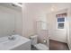 Bright half bathroom with white fixtures, storage, and wood-look flooring, perfect for guests at 9960 Kline St, Broomfield, CO 80021