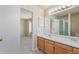 Bright bathroom featuring double sink vanity with updated counter tops and a shower with glass doors at 9960 Kline St, Broomfield, CO 80021