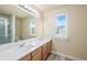 Well-lit bathroom features double sinks, vanity, shower and a large mirror for a functional space at 9960 Kline St, Broomfield, CO 80021